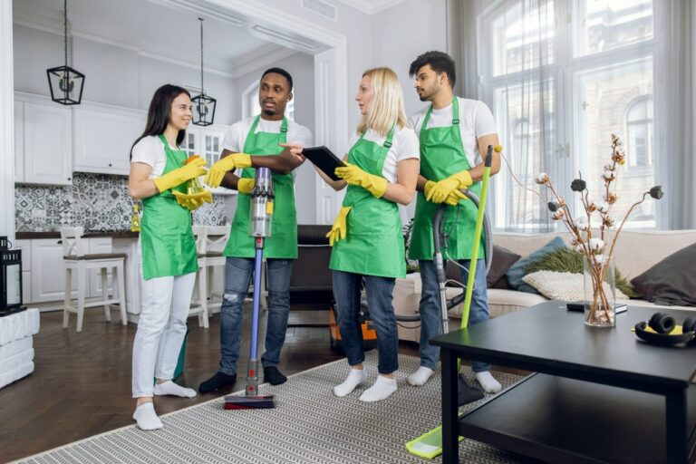 multiracial team of cleaning service using digital tablet